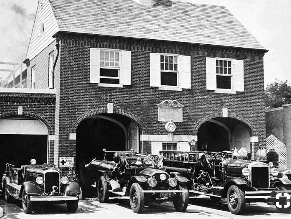 Vintage firehouse with fire trucks